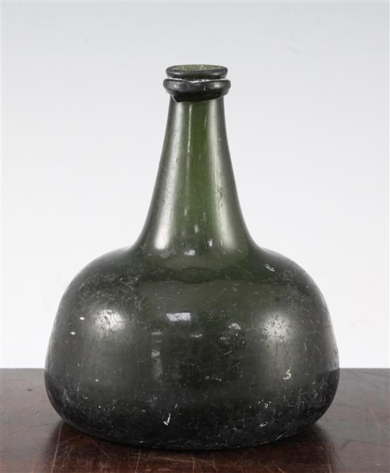 An English dark green glass onion shaped wine bottle, early 18th century, 18cm